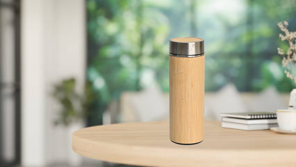 Bamboo water bottle on a wooden table with a blurred indoor background