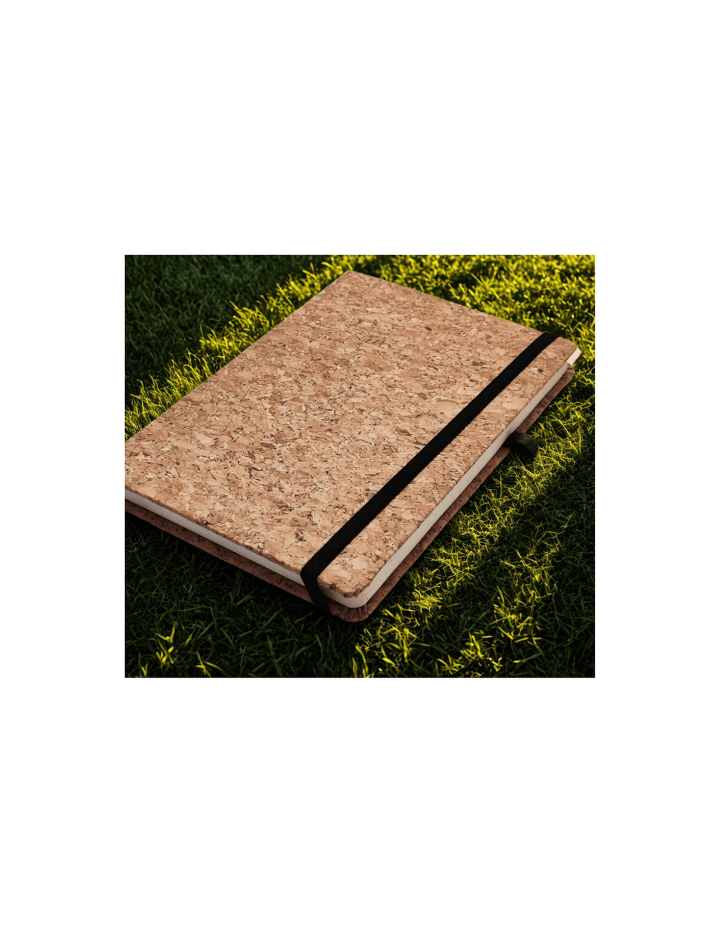 Cork notebook with a black strap on a grass background