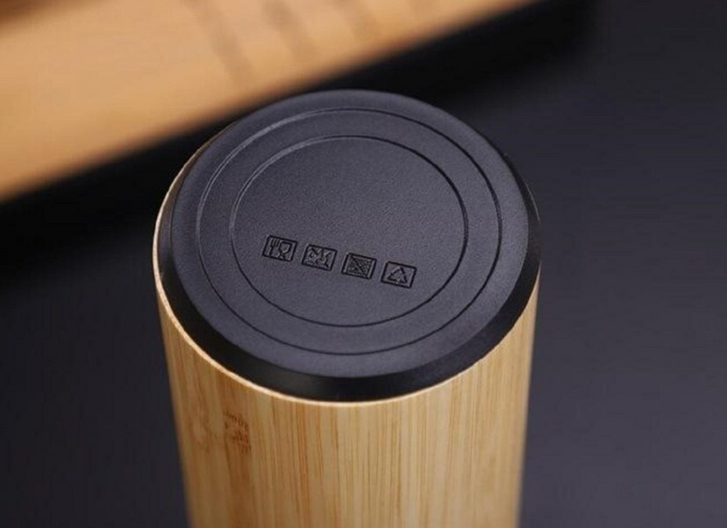 bamboo cylindrical product with black lid on a dark surface