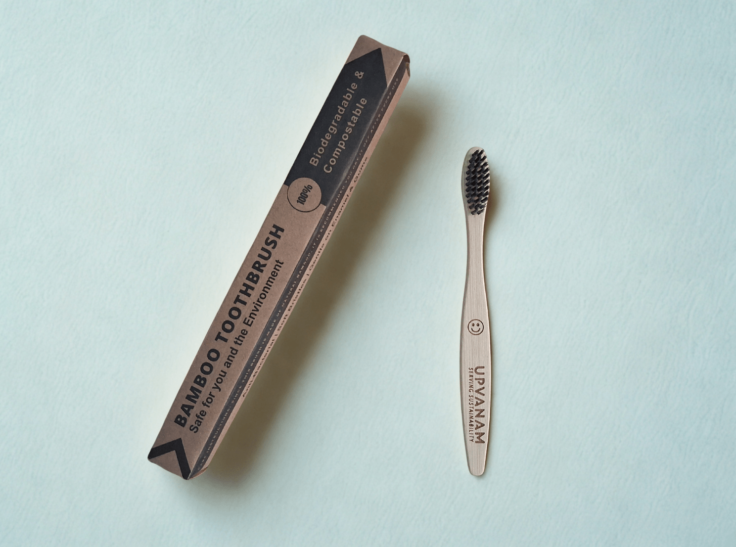 Organic Bamboo toothbrush with eco friendly packaging on a light blue background